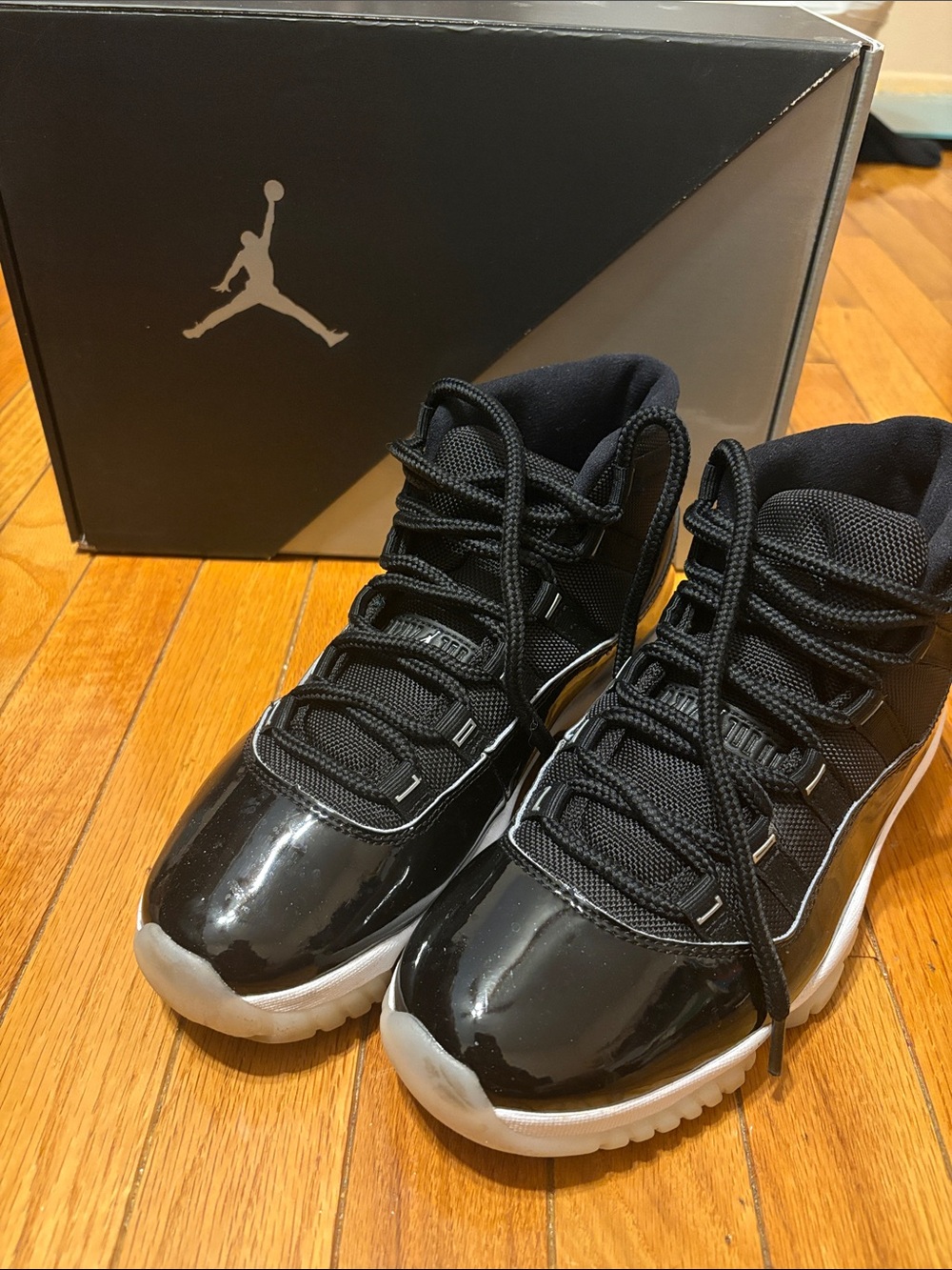 Air Jordan 11 Retro Black Patent and White-Trim High-Top Sneakers